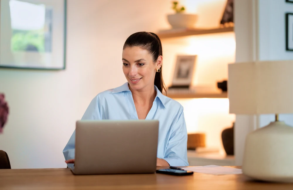 Woman sitting at desk using laptop