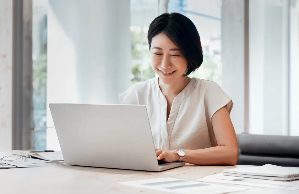 Smiling woman using laptop