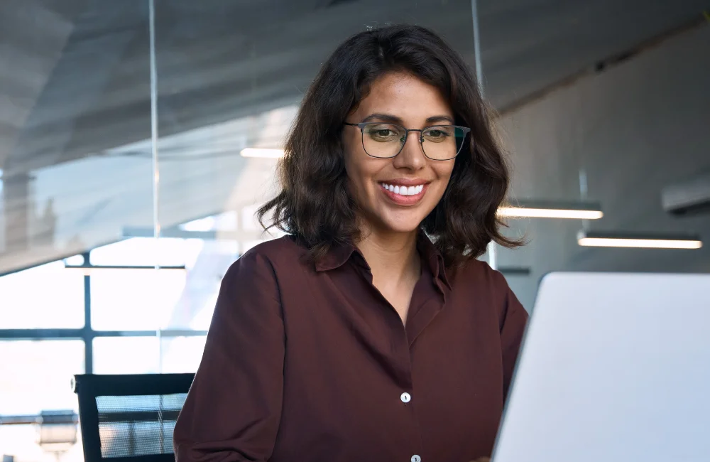 Happy woman using laptop