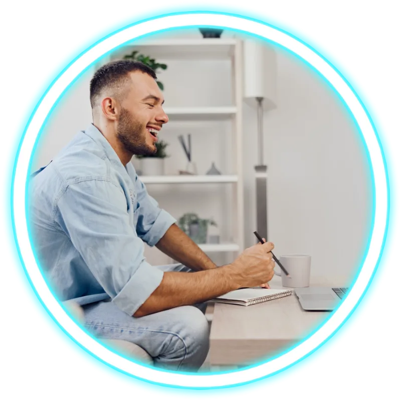 Man at home smiling looking at laptop