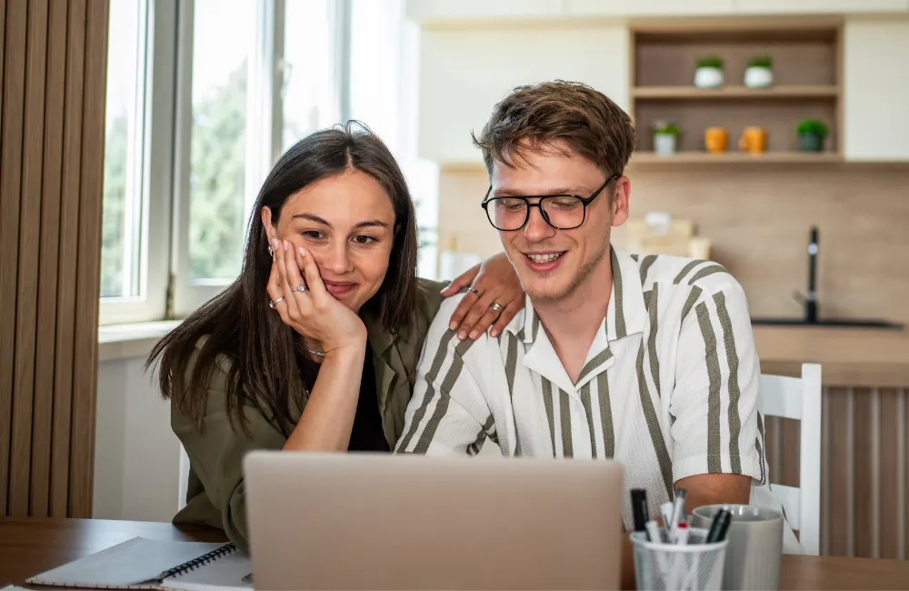 Two friends looking at laptop