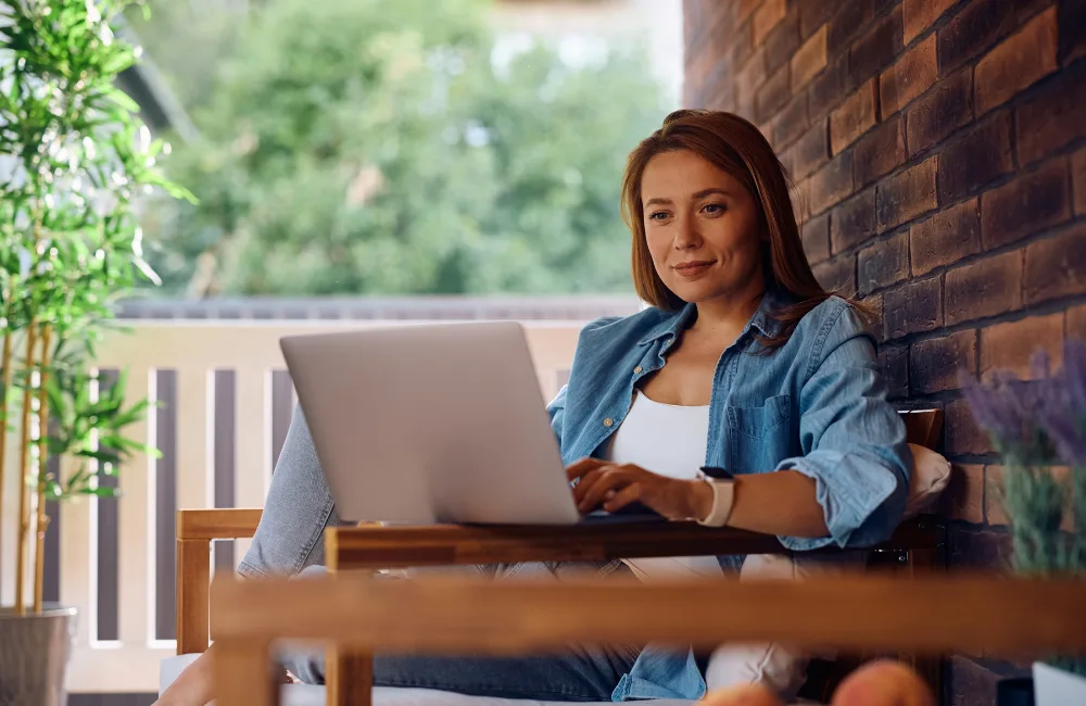 Woman sitting outside using laptop